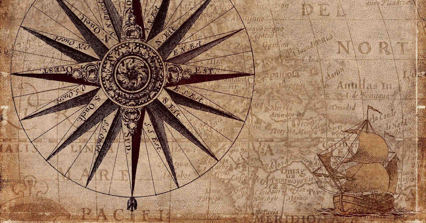 Sur une ancienne carte sont représentées une rose des vents et un bâteau.