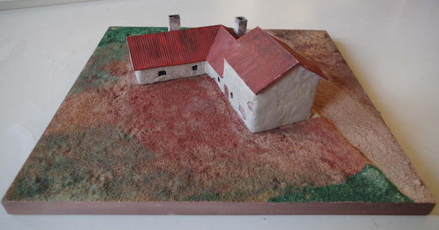 Maquette présentant un bâtiment en L.