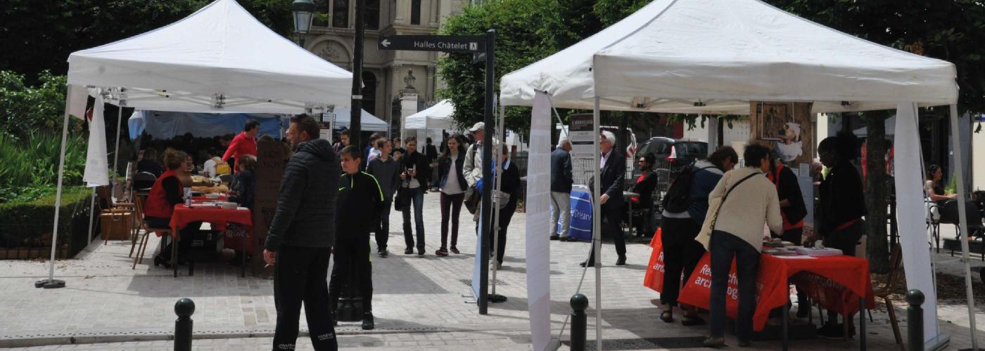 Le public se déplace autour de stands tenus par des archéologues